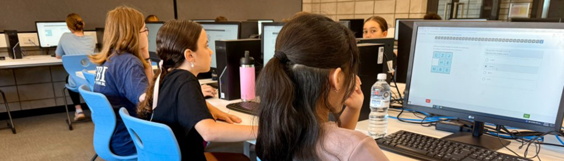 Academic Extension Program - students sitting test at computers Banner