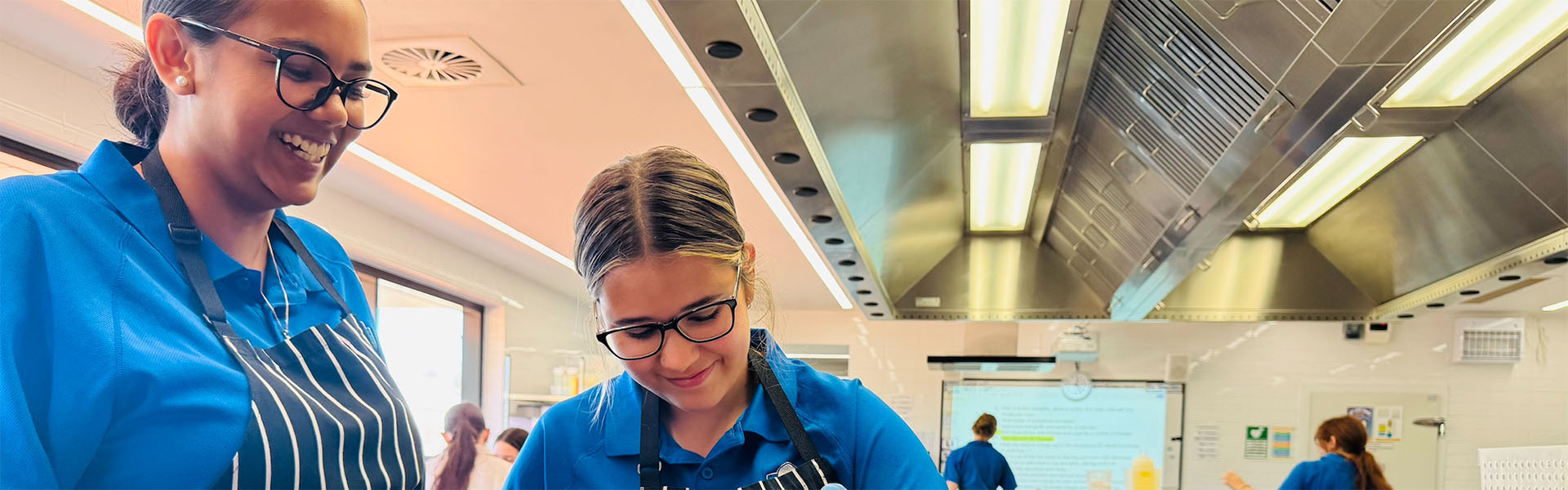Girls cooking in state of the art commerical kitchen at Broome Senior High School